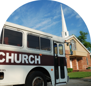A church bus in front of a church