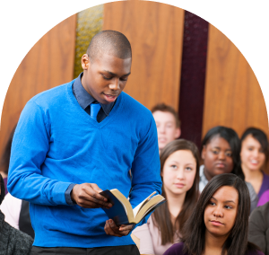 Man standing up in a courtroom with a bible in his hand.