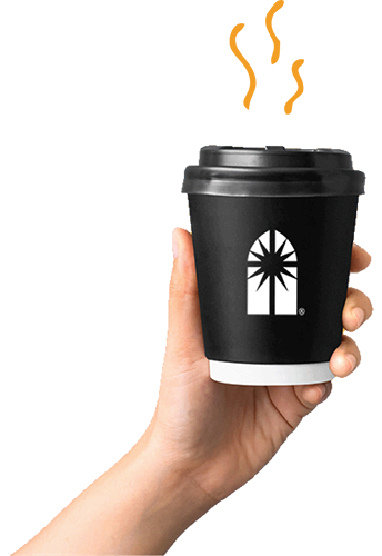 An image of someone holding a coffee cup with the Brotherhood window logo