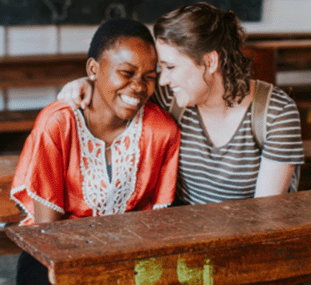 Image of two women bonding together on a mission trip